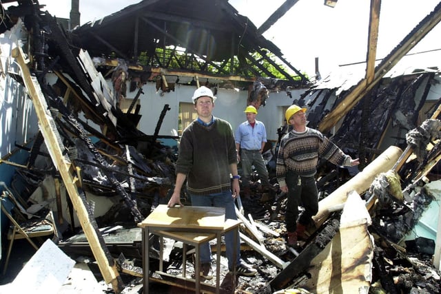 St James Church on Low Lane at Horsforth was devastated by fire. Pictured, from left, are church members John Evans, Chris Webb and Rob Newby looking at the damage.