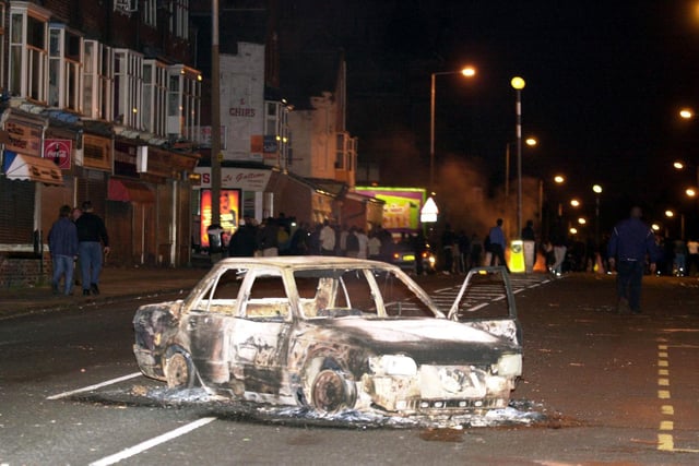 A burned out car in Leeds city centre after hundreds of rioters piled on to the streets setting alight cars and throwing bricks. After a two-hour stand-off in which police had kept their distance, trouble again flared up when riot officers and police dogs moved into action.