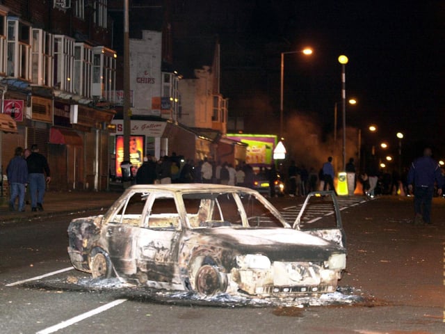 A burned out car in Leeds city centre after hundreds of rioters piled on to the streets setting alight cars and throwing bricks. After a two-hour stand-off in which police had kept their distance, trouble again flared up when riot officers and police dogs moved into action.