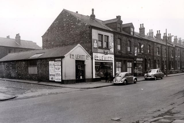 Meanwood Road in April 1958 and in focus are the premises of Eva Levitt Ltd, china and hardware dealer. Moving right is the Paper Trading Company, Leeds Ltd. Then a grocers shop. Delaware Street is on the left.