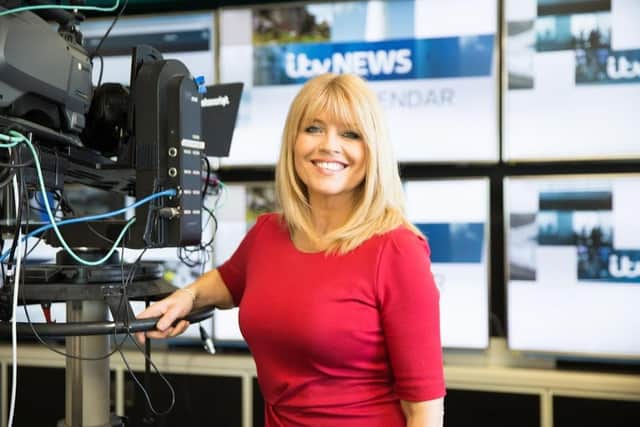 Christine Talbot in the studio wearing one of the dresses she is now donating.