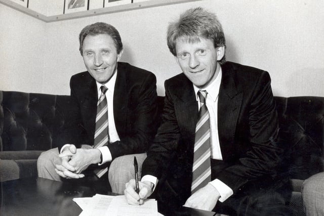 Gordon Strachan signs on the dotted line. He is pictured with manager Howard Wilkinson.