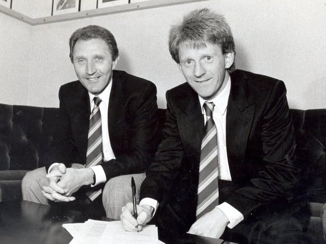 Gordon Strachan signs on the dotted line. He is pictured with manager Howard Wilkinson.