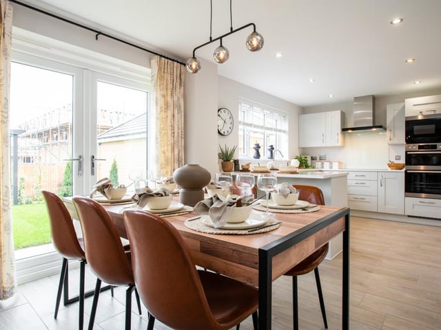 This includes a dining and seating area, with access to the garden and a separate laundry.