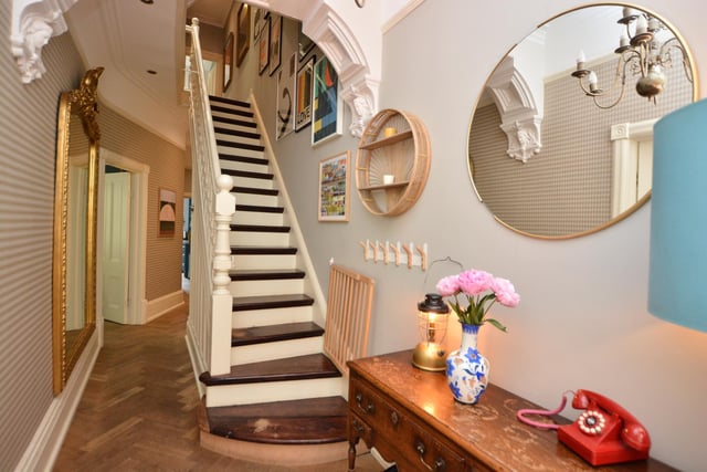 A ground floor entrance hall has lovely decorative features including an original front door with stained and etched glass panels, ceiling cornicing with moulded arch and staircase to the first floor with original spindled balustrade.