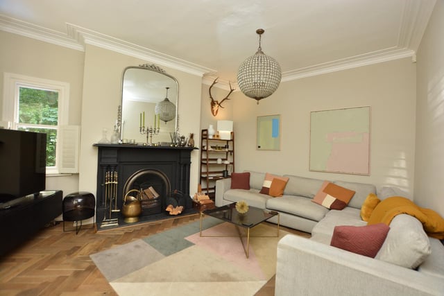 Off the hallway is a beautiful living room which has an attractive period fireplace and open fire.