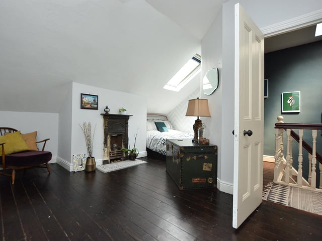 The second floor has two bedrooms, both with cast iron fireplaces and a boxroom for storage.