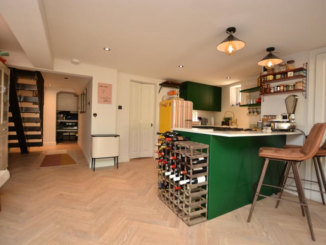 There is a spacious sitting/dining area with bi-folding doors onto a lovely enclosed courtyard garden, and this room also has a food prep area, making it perfect for entertaining.