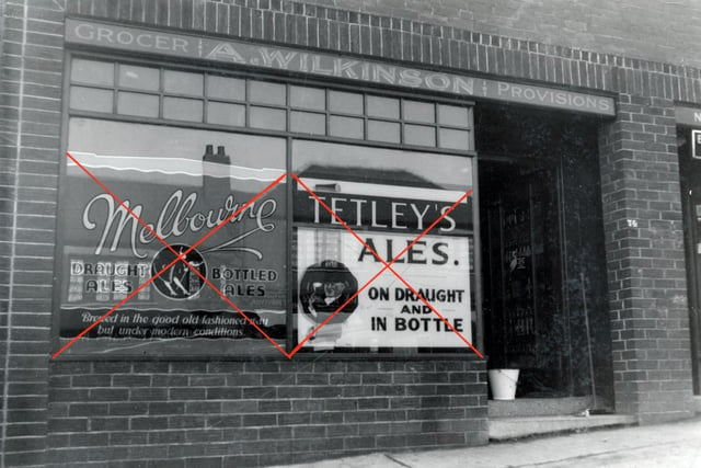 A licensed grocers shop on  Brander Road pictured in April 1939. The shop window is obscured by advertisements for Melbourne and Tetley's beers.