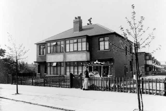 A pair of semi-detached houses on Coldcotes Avenue. One of them was home to the Granelli family, well known in Leeds as ice-cream makers. In this view, an ice-cream cart is in the garden with a lady serving customer.