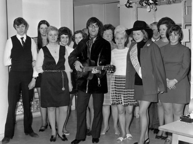Cliff Richard taken at Green Shield Stamps on Eastgate in April 1970. He is surrounded by a group of staff dressed in typical fashion of the time.