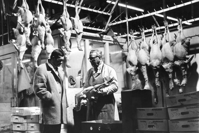 An early morning buyer inspects turkeys in the poultry section of Leeds Wholesale Market in February 1970.