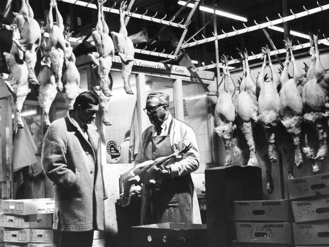 An early morning buyer inspects turkeys in the poultry section of Leeds Wholesale Market in February 1970.