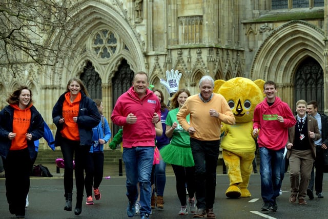 Mike Tomlinson and Harry Gration lead a group of charity fundraisers  outside York Minster at the launch of the 4th Plusnet Yorkshire Marathon in 2016