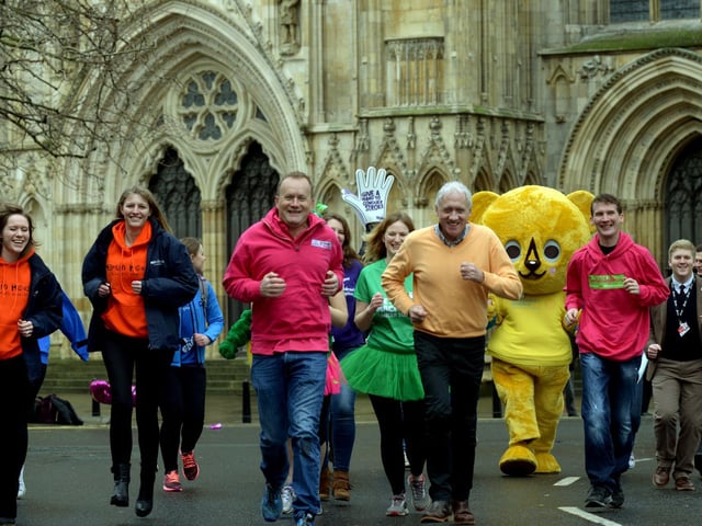 Mike Tomlinson and Harry Gration lead a group of charity fundraisers outside York Minster at the launch of the 4th Plusnet Yorkshire Marathon in 2016