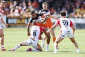 Tigers' Kenny Edwards is tackled by Mitchell Pearce. Picture by John Clifton/SWpix.com.