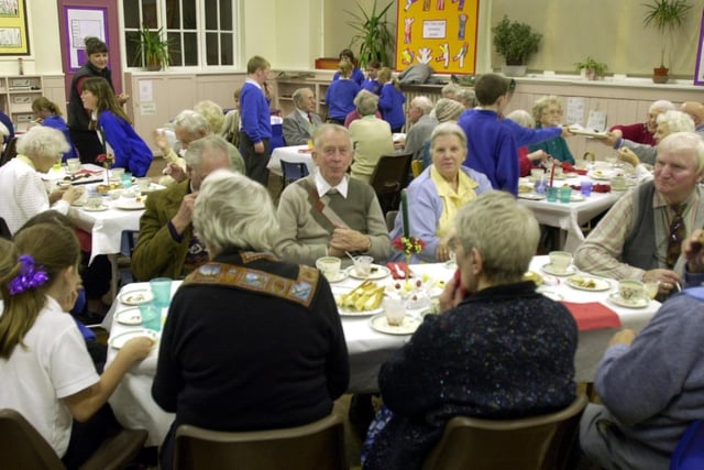 Cross Hills Infant School pupils serve Christmas lunch to members of Morley Community Elderly Aid in December 2001.