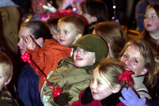 Smiling faces in the crowd after Morley Christmas lights switch-on in November 2001.