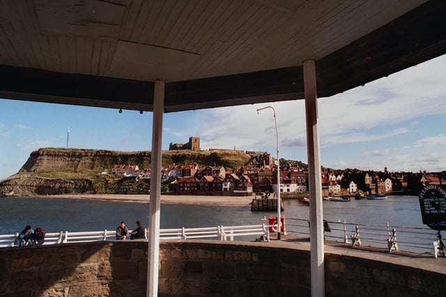 Whitby's famous harbour is framed by one of the public shelters on quay in March 1999.