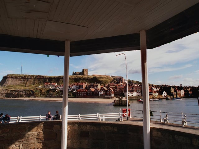 Whitby's famous harbour is framed by one of the public shelters on quay in March 1999.