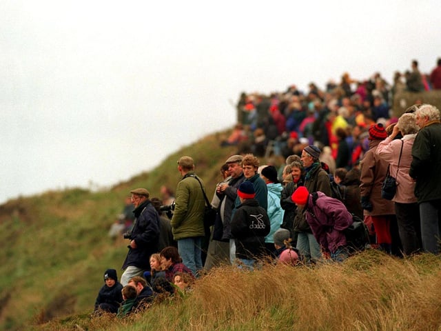 The crowds gather above Whitby Harbour to see the HMS Endeavour return to the town for the second time in 1997.