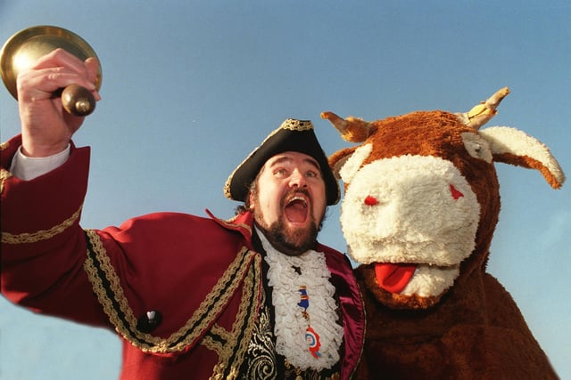 The British Champion Town Crier Andy Lowe from Whitby and Robin Hoods Bay proclaims the lifting of the beef export ban with the help of a pantomime cow in November 1998.