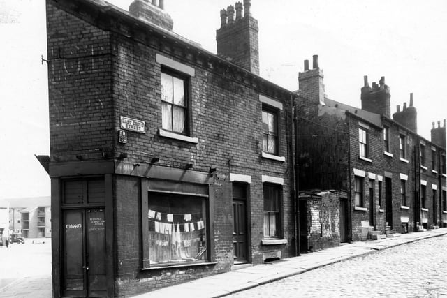 A shop is on the corner with East Grove Street in May 1960. To the left is Accommodation Road, a block of new Council maisonettes can be seen. This building work was carried out at the same time as the demolition of the old street.