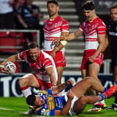 Overpowered: St Helens' Joe Batchelor (left) celebrates scoring his side's sixth try in the 42-12 defeat of Leeds Rhinos. Picture: Martin Rickett/PA Wire.