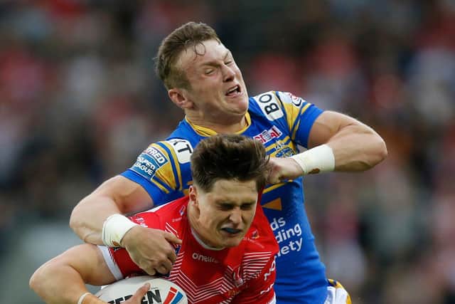 Leeds Rhinos' Harry Newman attempts to tackle St Helens' Jonathan Bennison. Picture: Ed Sykes/SWpix.com.