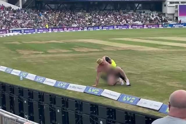 Security staff tackle the streaker at Headingley. Picture: SWNS