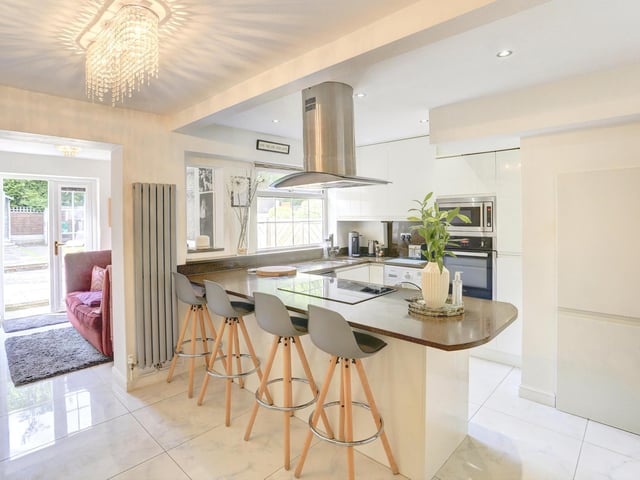 Other kitchen features include an integrated electric hob with extractor fan, a dishwasher and space for a free standing fridge and freezer. The space benefits from tiled flooring, spotlights and a breakfast bar with space for seating.