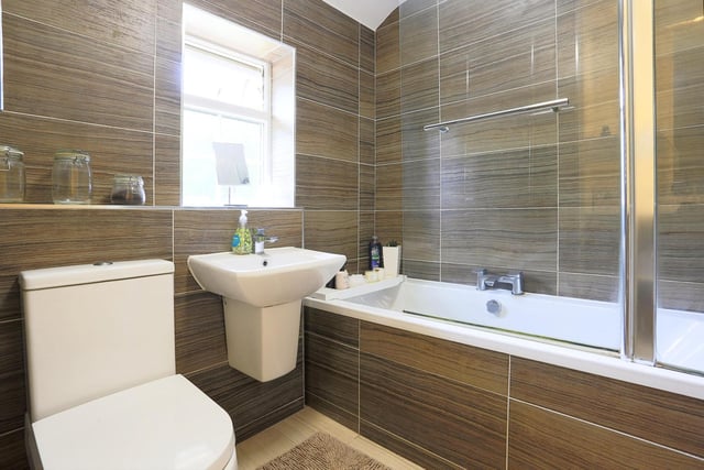 The house bathroom is fitted with a modern three-piece suite, comprising of a bath with shower over, wall-mounted wash hand basin and low level flush toilet.