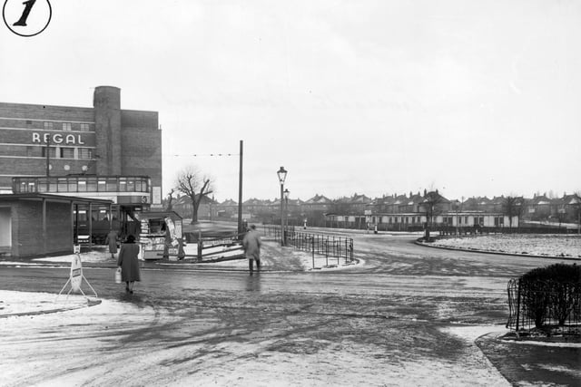 The roundabout looking onto Cross Gates Ring Road and showing the Regal cinema in January 1956. Small newsagents kiosk with a road sign to the right.