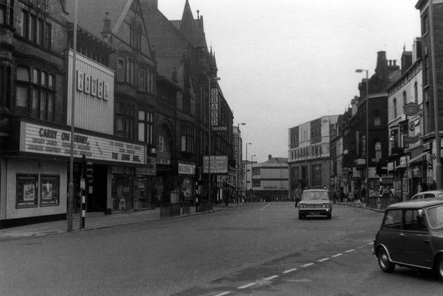 New Briggate looking south-west from the junction with Merrion Street, right, towards The Headrow. On the left, the Tower Cinema is showing the film 'Carry On Henry' with Sidney James and Kenneth Williams, which opened in the UK in 1971.