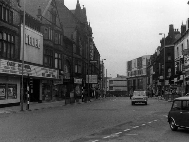 New Briggate looking south-west from the junction with Merrion Street, right, towards The Headrow. On the left, the Tower Cinema is showing the film 'Carry On Henry' with Sidney James and Kenneth Williams, which opened in the UK in 1971.