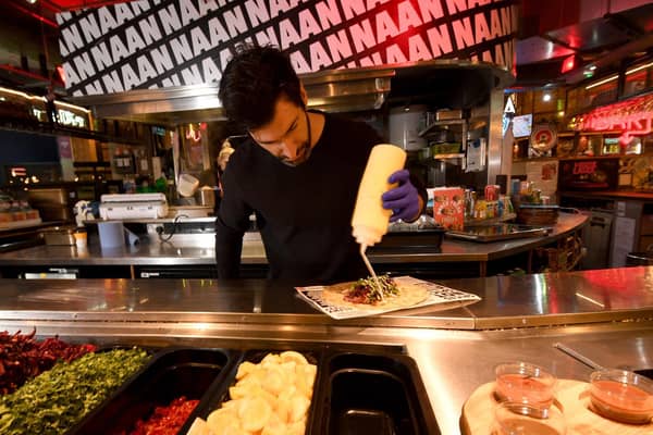 Mark Wright, the founder of Rola Wala, making up a naan roll