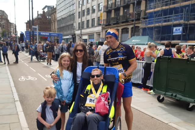 Sir Kevin Sinfield with Rob Burrow and family at the Leeds 10K finish line. PIC: Andrew Hutchinson