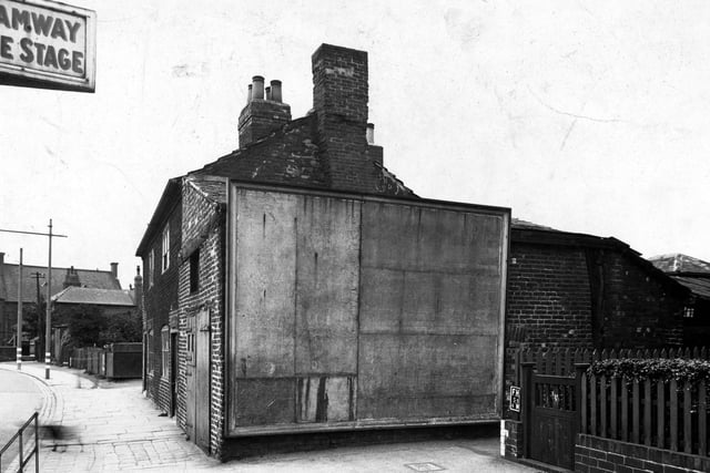 A blank the advertising hoarding on Town Street in June 1945.