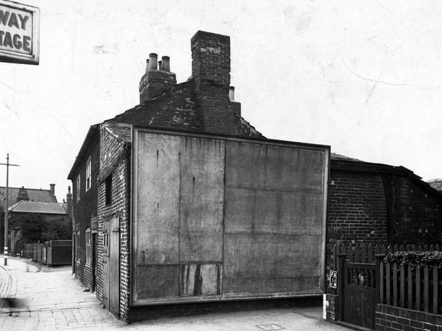 A blank the advertising hoarding on Town Street in June 1945.