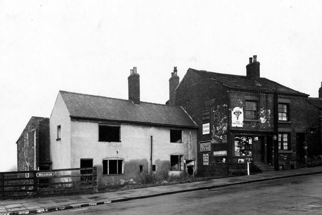 Millshaw Lane showing Squire Brown's grocers shop next to two derelict cottages in December 1942.