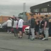 Crowds gather for a 'car meet' event in Lowfields Road in Leeds.