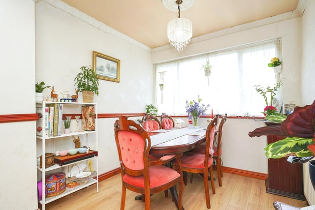 The open plan dining room has a window to the rear, a storage cupboard and radiator.