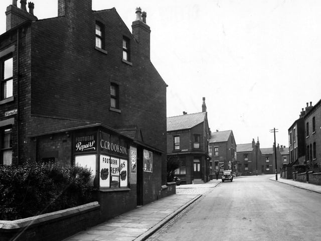 Looking west along Rowland Road in August 1949. C. Crookson footwear repairs is in the foreground. The ends of Clovelly Place and Clovelly Avenue are visible.