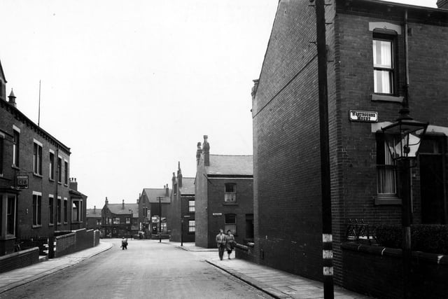 Two children play in Rowland Road in August 1949. On the right a gas street lamp is prominent. Behind it are the junctions with Westbourne Mount, Bude Road and Clovelly Row. On the left is Rowlands Road Working Men's Club & Institute.