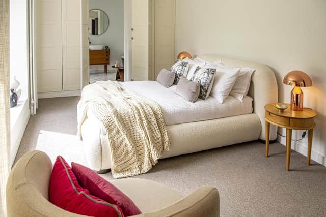 One of the bedrooms with an ensuite with free-standing bath and mid-century furniture.