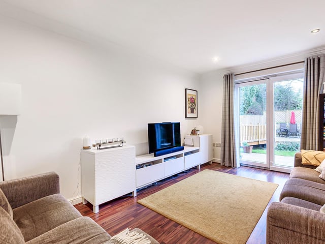 A cozy lounge with sliding doors opens up to the beautiful garden.