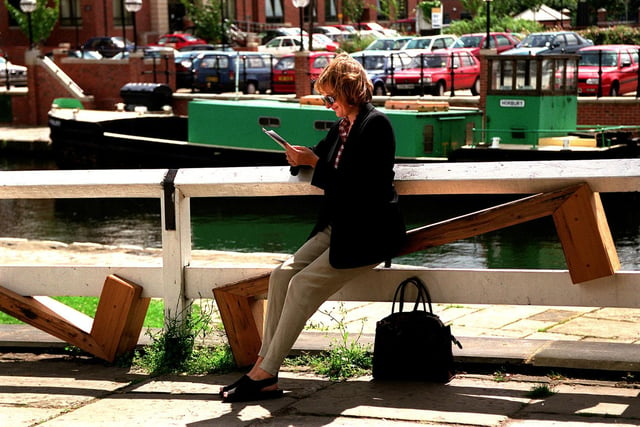 A passer-by tries to get comfortable on an unsittable seat at Granary Wharf in Leeds ciity centre.
