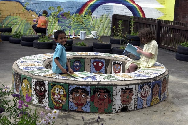 Royal Park Primary pupils Mitesh Patel and Jenner Sloss make use of the mosaic bench in the school playground in July 2003.