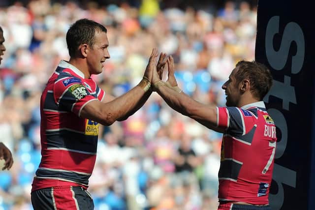Leeds Rhinos' Danny McGuire, left, celebrates with team-mate Rob Burrow after scoring the fourth of his five tries against Bradford at the Etihad Stadium in 2012. Picture: Clint Hughes/PA Wire.