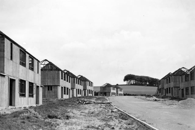 A street of houses nearing completion on the Moortown housing estate in May 1949 with King Alfred's Castle in the distance.